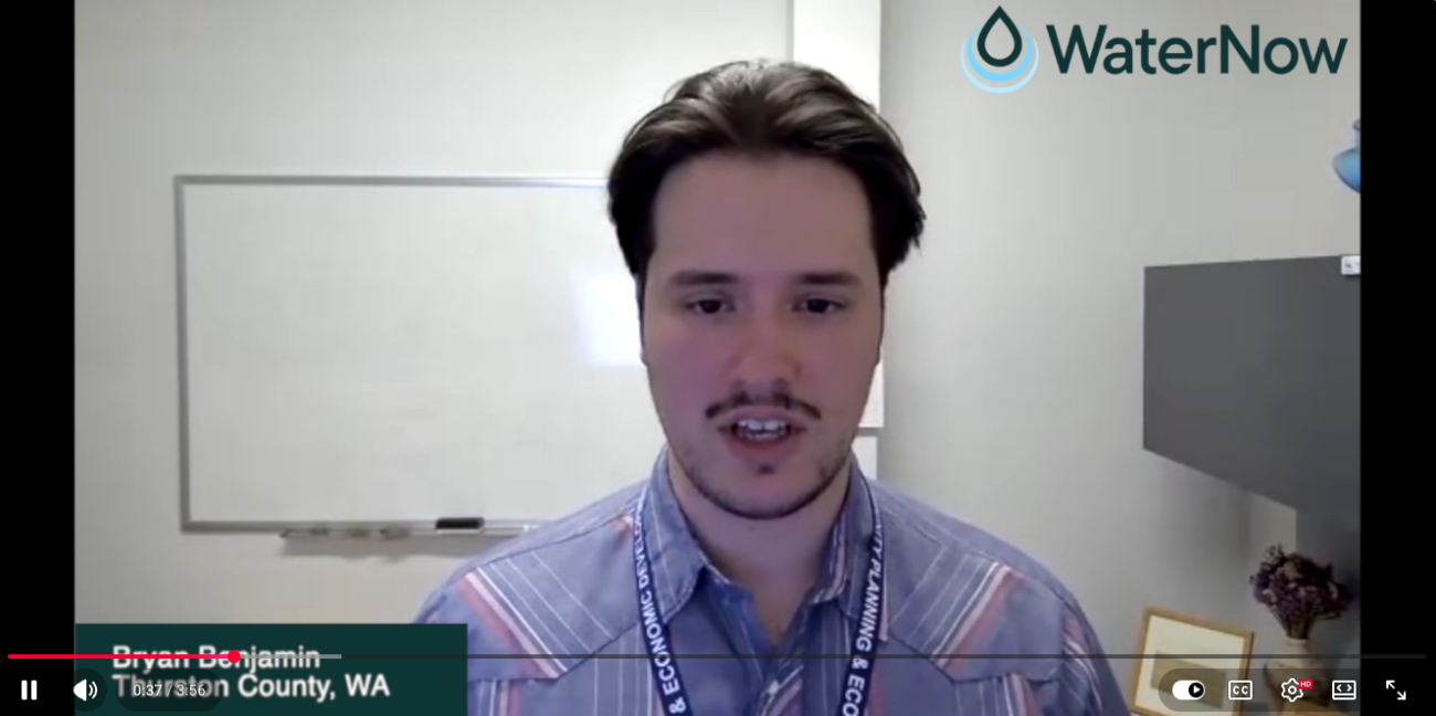 Male presenter in a striped button-down shirt speaking on a video call; WaterNow logo in the top-right corner and a lower-third caption showing a name and location.