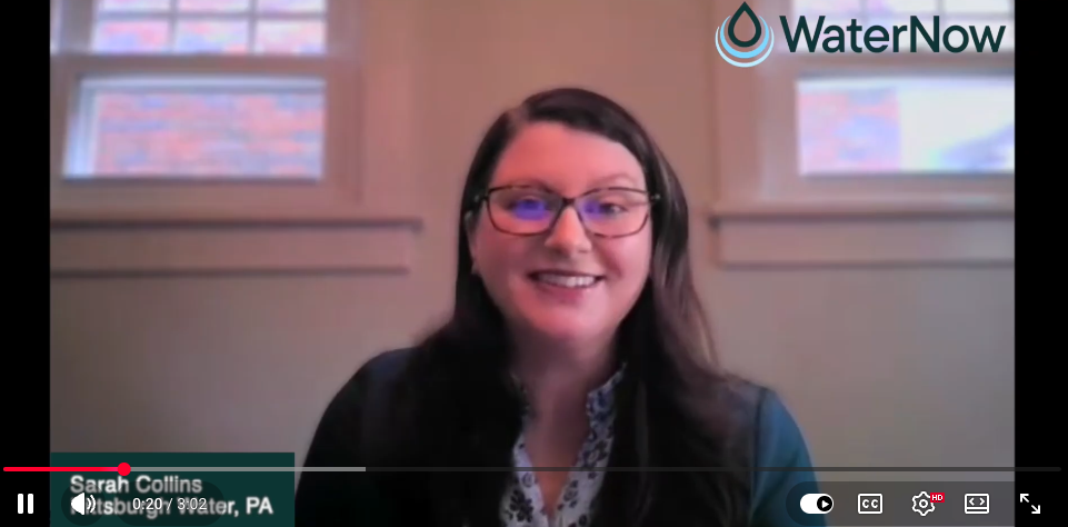 Smiling woman with glasses speaks in a WaterNow presentation video; name Sarah Collins appears on screen (lower-left).