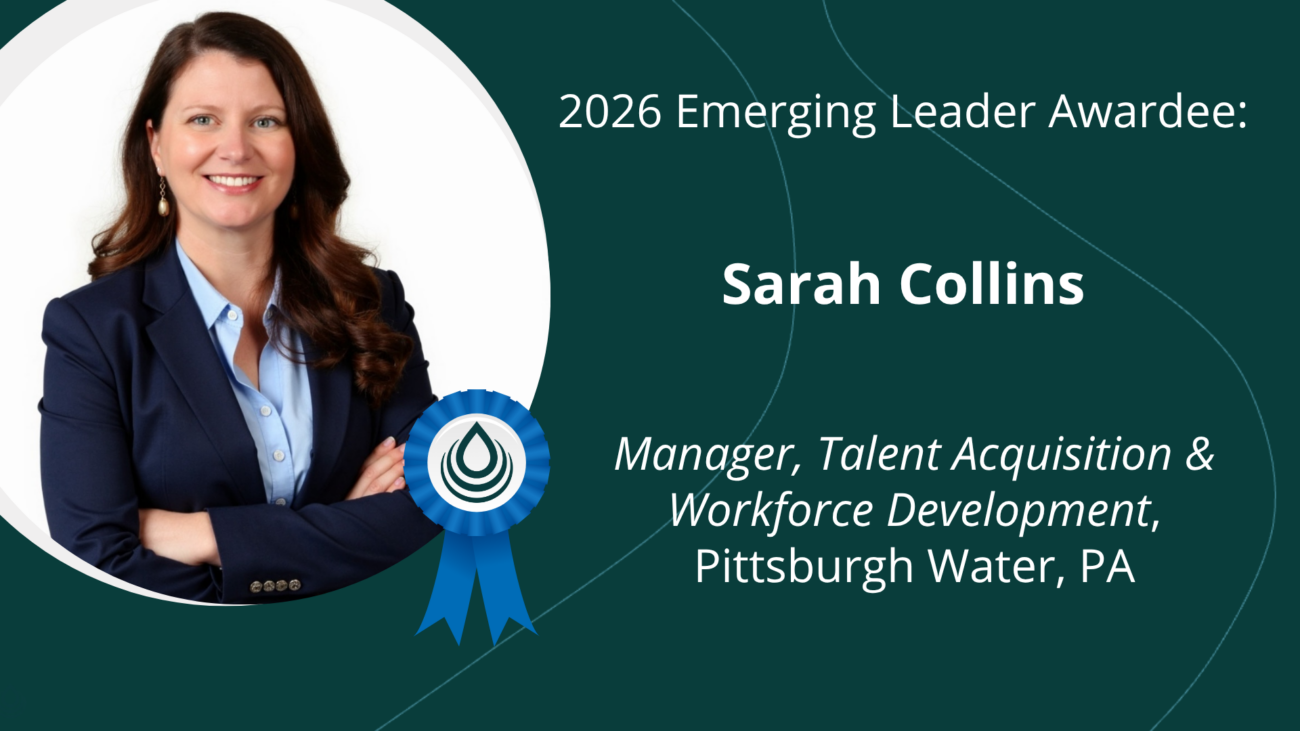 Portrait of Sarah Collins, 2026 Emerging Leader Awardee, in a navy blazer on a teal banner.
