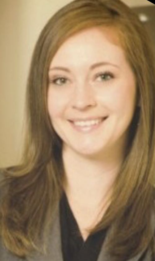 Portrait of a young woman with shoulder-length light brown hair and a warm smile.