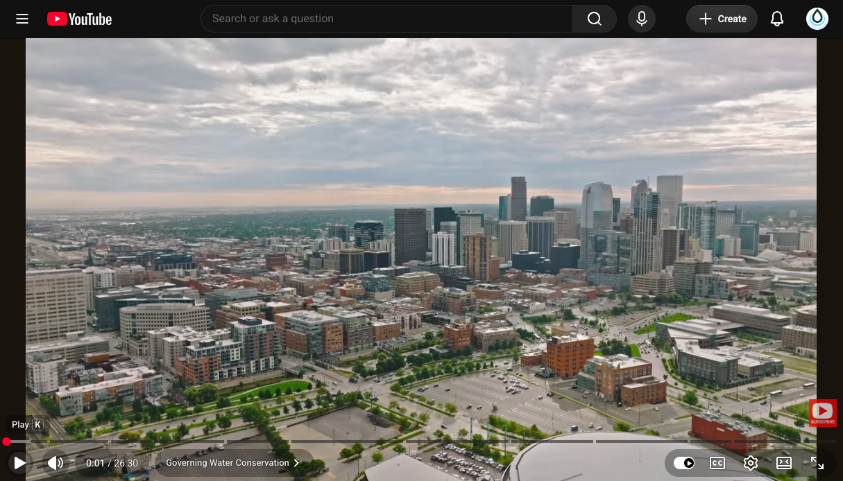 Aerial view of a modern city skyline with tall skyscrapers and a dense downtown district.
